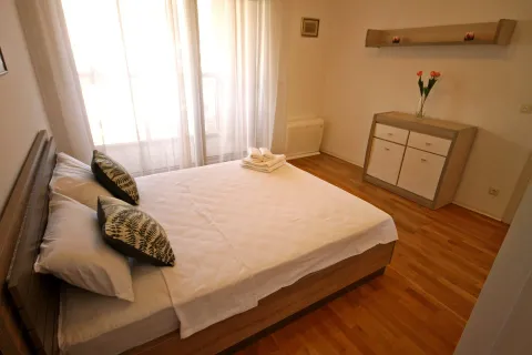 Bright bedroom with a double bed and a chest of drawers. - image 8