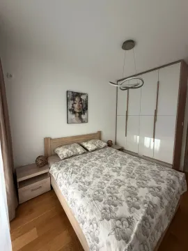 Bright bedroom with a double bed, wardrobe, and nightstands. - image 4
