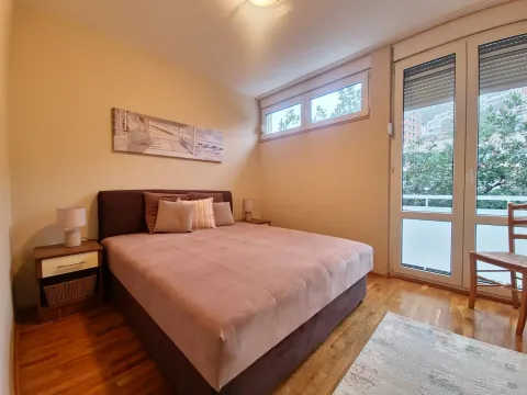 Furnished bedroom with a double bed, bedside tables, and access to the terrace. - image 8