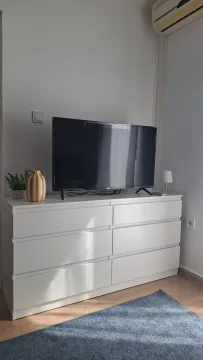 White dresser with a TV in the living room. - image 4