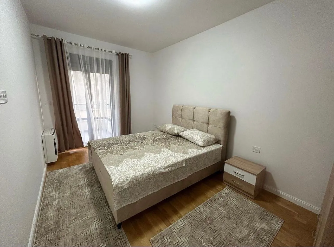 Furnished bedroom with a double bed, rugs, and access to the terrace.