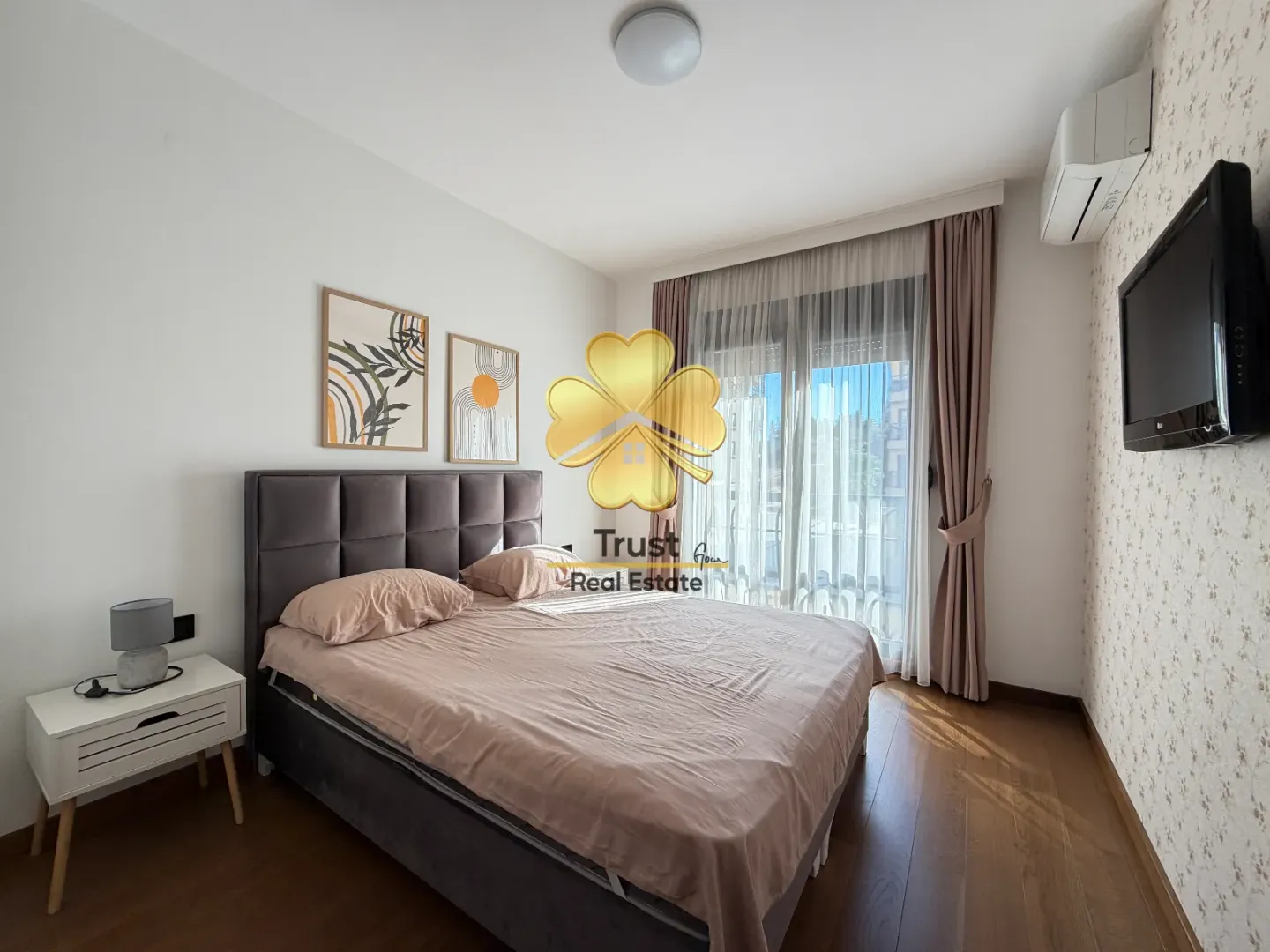 Furnished bedroom with a double bed, nightstand, and terrace access.