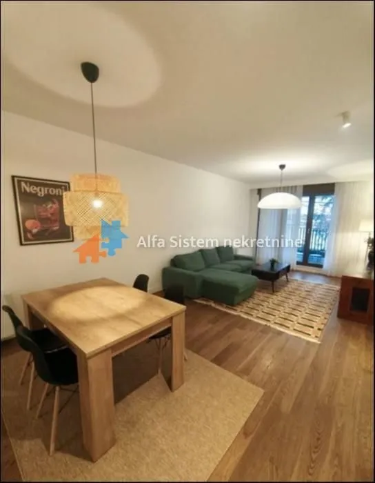 Living room with dining area, sofa and access to the terrace.