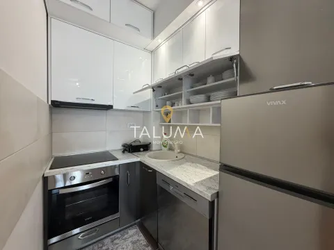 Compact white kitchen equipped with appliances. - image 2