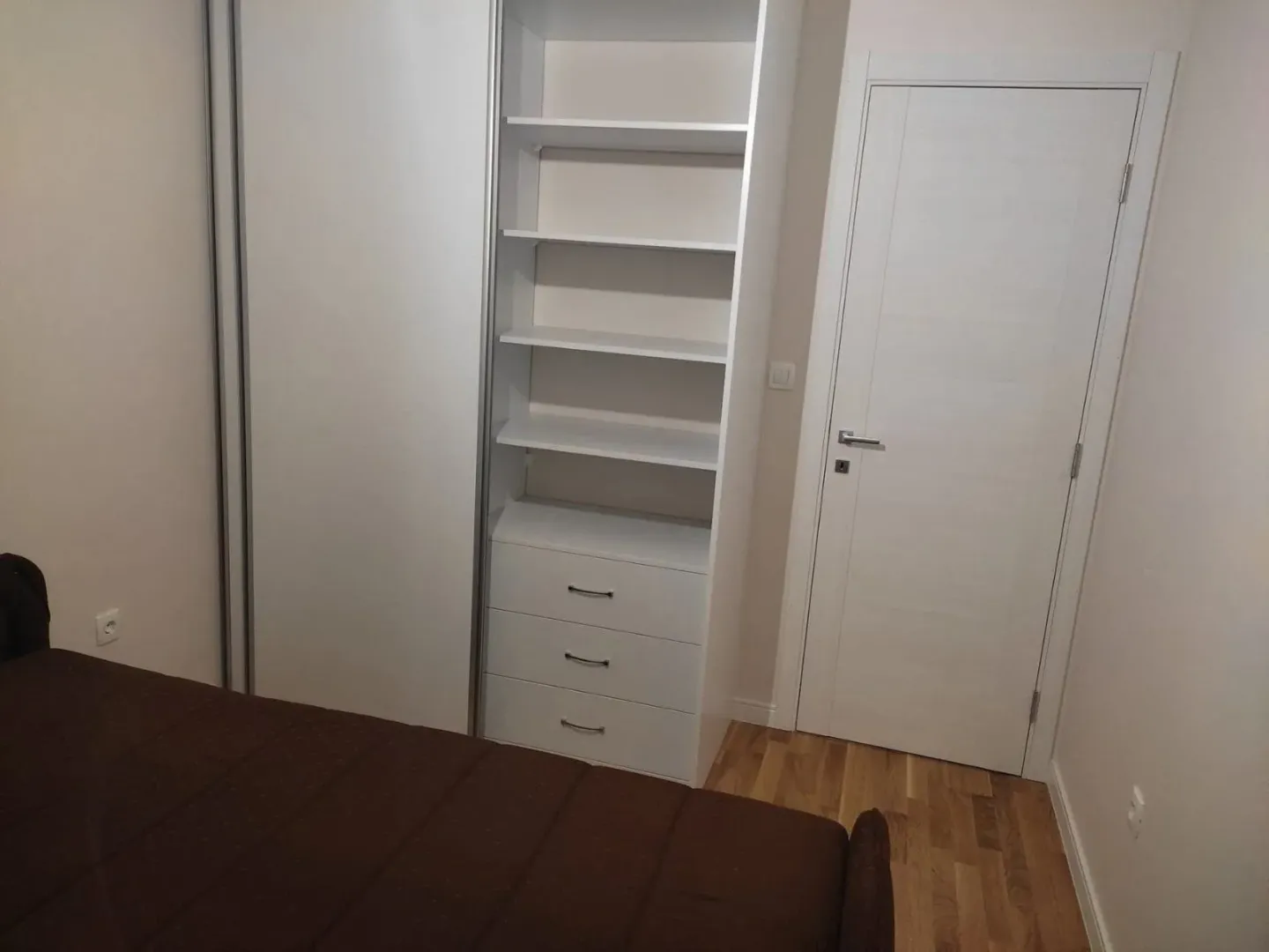 Furnished bedroom with a built-in closet and a bed.