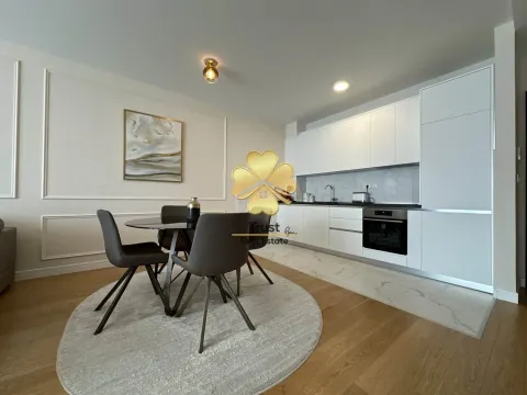 Modern kitchen with a dining area and white cabinetry. - image 5