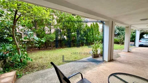 Covered terrace overlooking the landscaped yard and greenery. - image 8