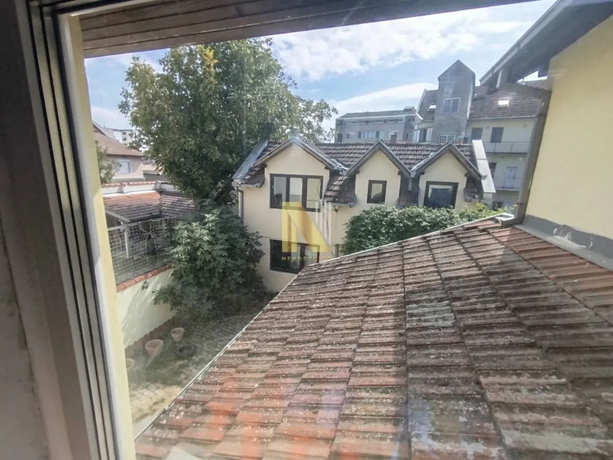 View through the window of surrounding rooftops and buildings.