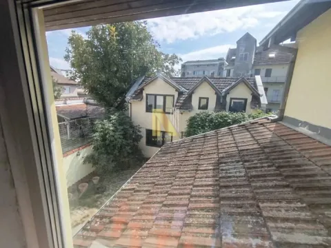 View through the window of surrounding rooftops and buildings. - image 16