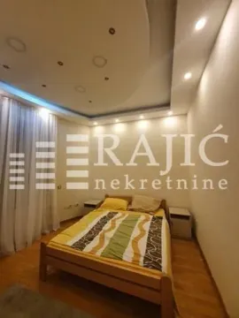 Bedroom with a double bed and a drop ceiling with lighting. - image 5