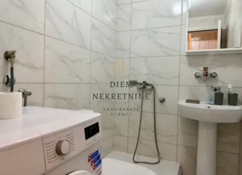 Small bathroom with white marble tiles, washbasin and washing machine. - image 6