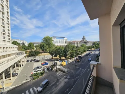 View from the terrace overlooking the city street, park, and surrounding buildings. - image 3