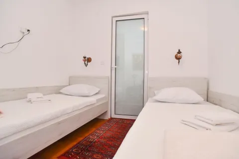 Bedroom with two single beds and access to the terrace. - image 7