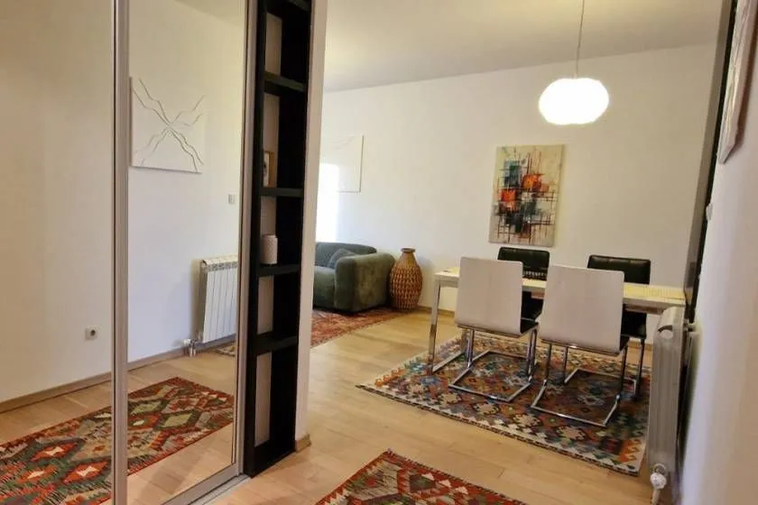 View from the hallway into the bright living room with a dining area.