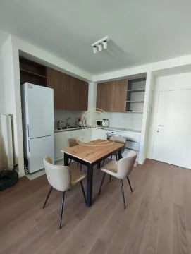 Kitchen with a dining table and wooden elements. - image 3