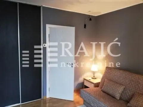 Furnished bedroom with a sofa bed and built-in wardrobe. - image 9