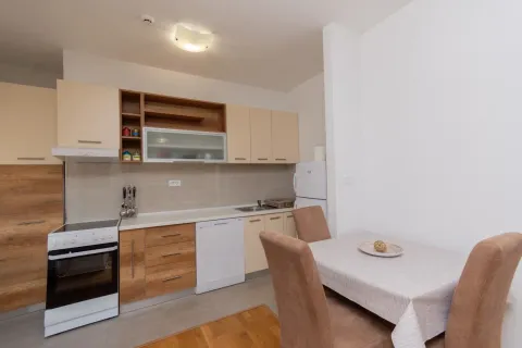 Modern kitchen with dining area and built-in appliances. - image 2