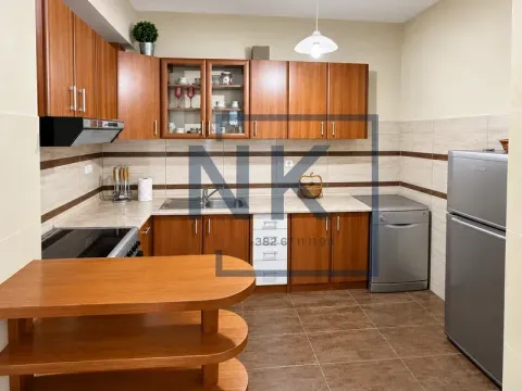 Kitchen equipped with wooden cabinets and basic home appliances. - image 3