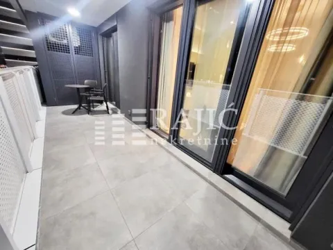 Modern tiled terrace with seating furniture and glass railings. - image 5