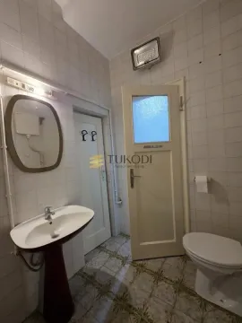 Smaller bathroom with a washbasin, toilet bowl and wall tiles. - image 8