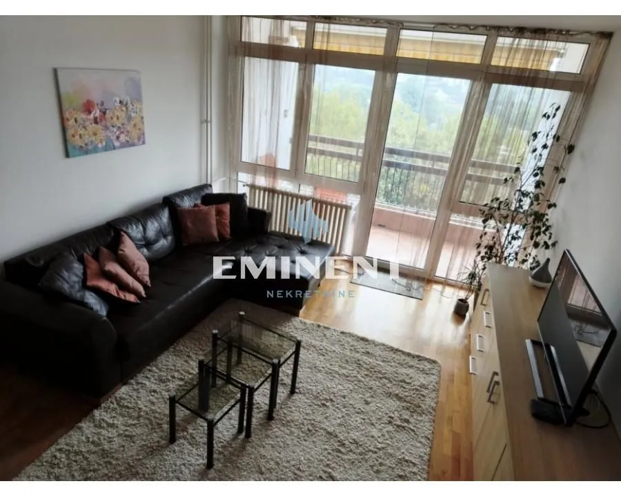 Living room with a sofa, coffee table, and access to the terrace.