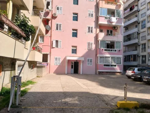 Pogled na spoljašnjost zgrade sa ulazom i parkingom ispred. - image 14
