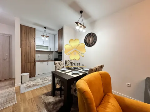 Living room with a dining area and kitchen. - image 3