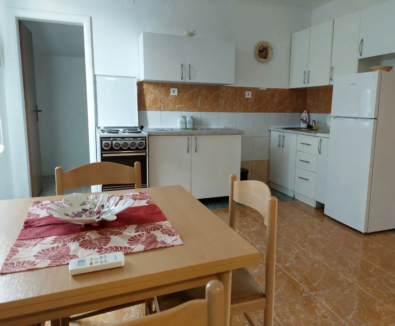 Dining area with a kitchen equipped with basic elements and white goods.