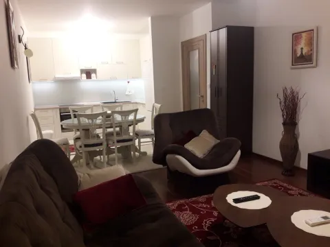 An open-plan living room with a dining area and kitchen in the background. - image 11