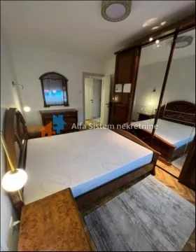 Furnished bedroom with a double bed, large wardrobe, and chest of drawers. - image 7