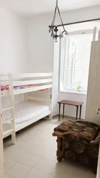 Bedroom with a bunk bed and a window. - image 10
