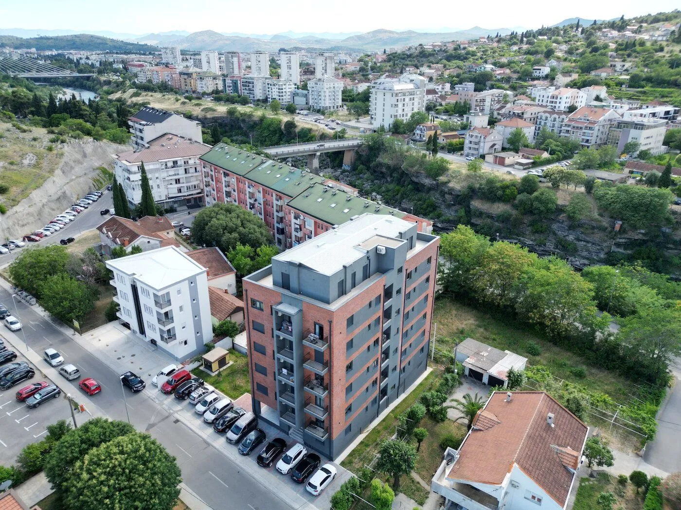 Aerial view of the residential building and the surrounding neighborhood.
