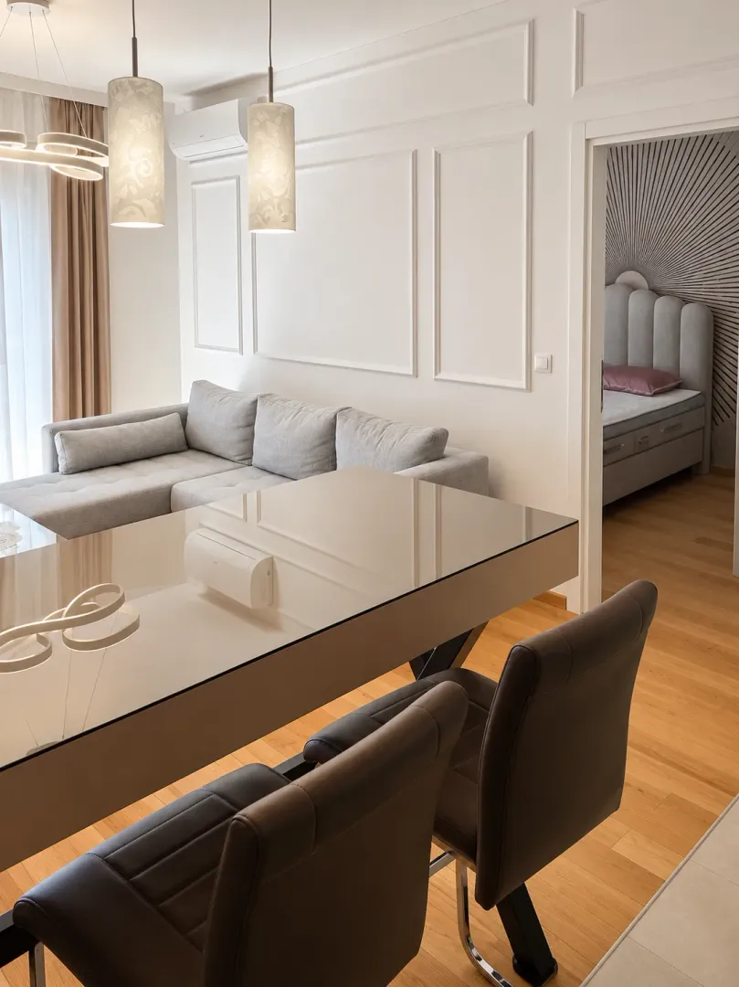 Living room with a dining table and a view of the bedroom.