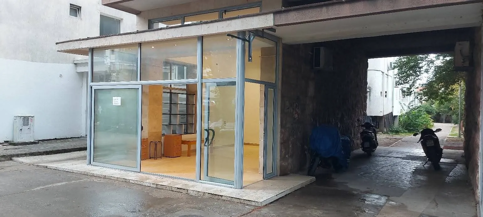 Exterior of commercial space with large glass storefront and passageway.