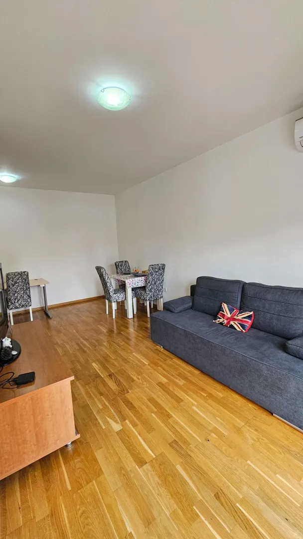 Living room with a sofa and dining table.