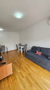Living room with a sofa and dining table. - image 4