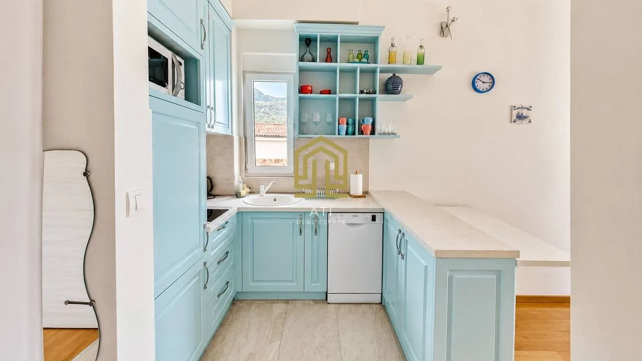 Bright kitchen with light blue cabinetry.