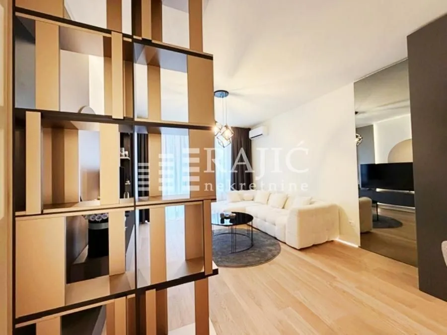 Modern and bright living room with a sofa and a decorative partition.