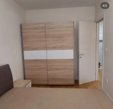 Bedroom with a double bed and a large wooden wardrobe. - image 4