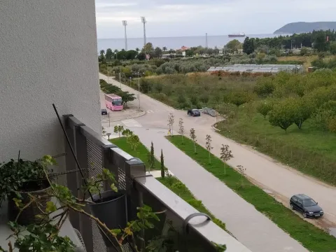 View from the balcony overlooking the surroundings, street, and sea. - image 11