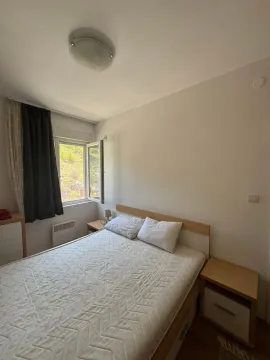 Bedroom with a double bed and a window overlooking greenery. - image 8