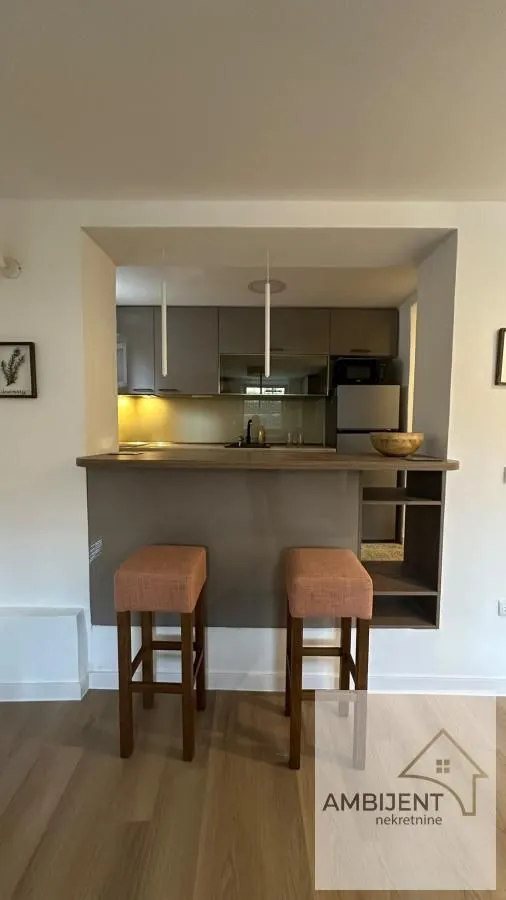 Kitchen with a breakfast bar and bar stools.