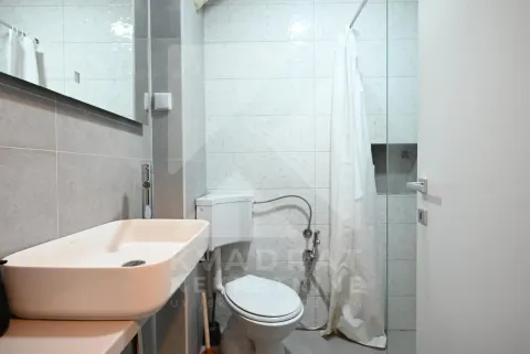Modern equipped bathroom with a washbasin, toilet, and walk-in shower. - image 3