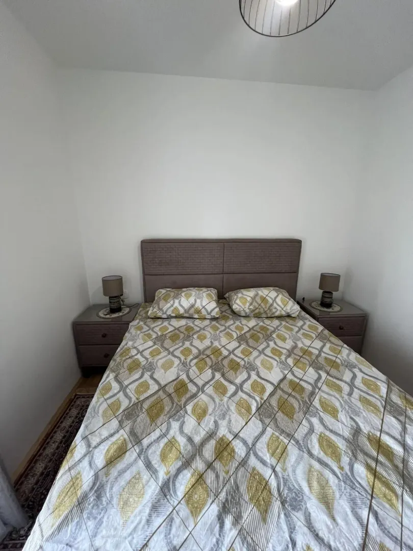 Bright bedroom with a double bed and nightstands.