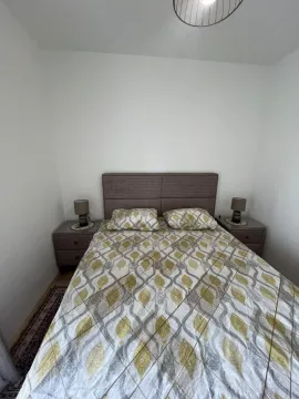 Bright bedroom with a double bed and nightstands. - image 9