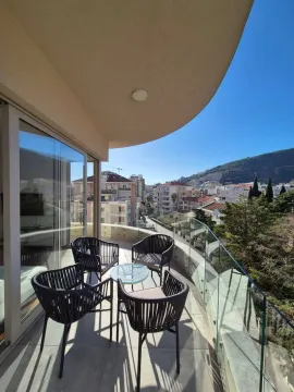 Furnished balcony with seating set and a view of the city and hills. - image 10