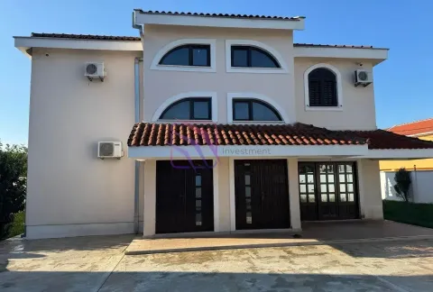 Front view of a multi-story house with a paved courtyard and arched windows. - image 3