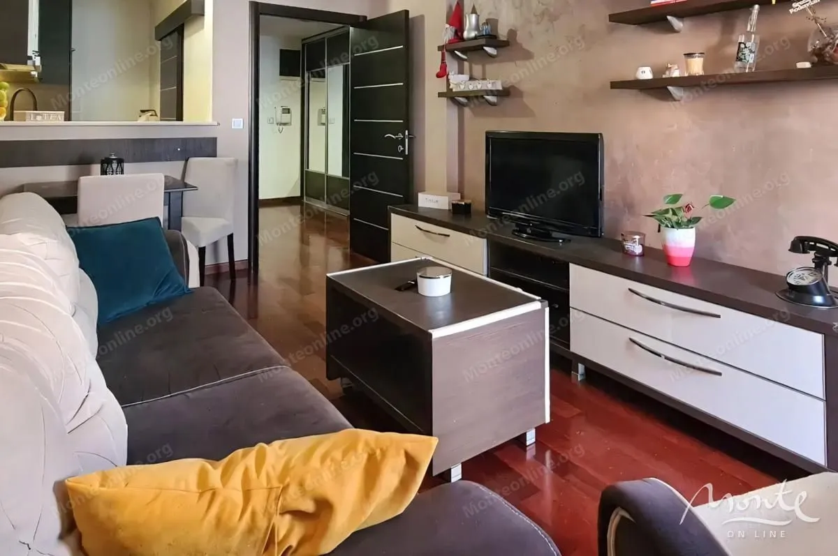 Living room with a sofa, TV cabinet and coffee table.