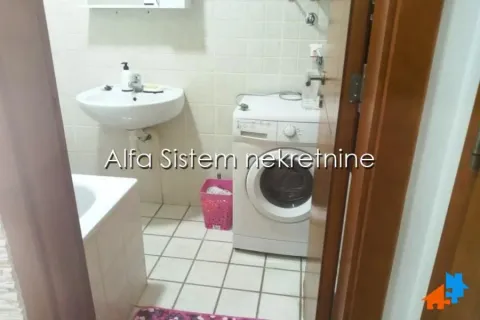 Small bathroom with a sink, bathtub, and washing machine. - image 13