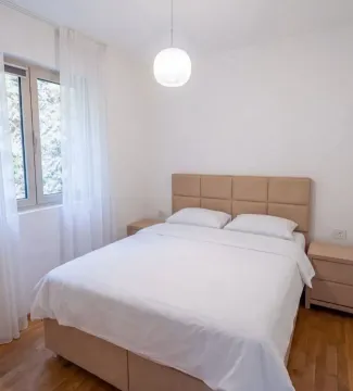 Bright bedroom with a double bed and bedside tables. - image 7
